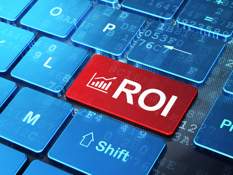 Finance concept: Growth Graph and ROI on keyboard background